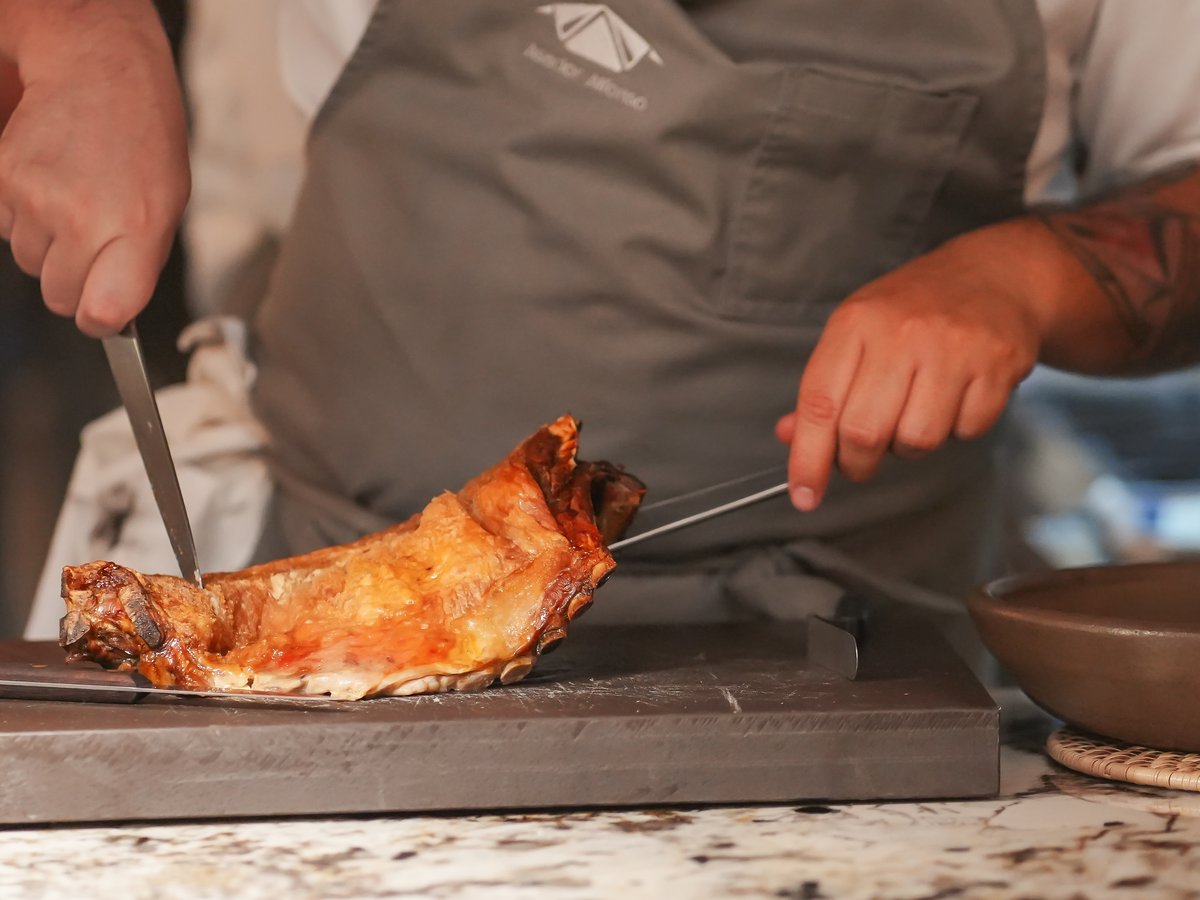 Lechazo — Slow roasted Spanish suckling lamb served with stew potatoes and green salad.
